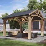 Aoxun cedar pavilion gazebo, gable roof, four posts, on a paved patio by a house