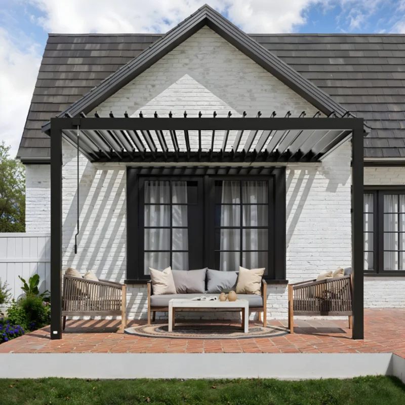 Backyard Discovery Evanston 12 x 10 ft. black steel louvered pergola mounted to a white brick house