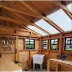 Sunshed interior with potting bench, pegboard and utility sink